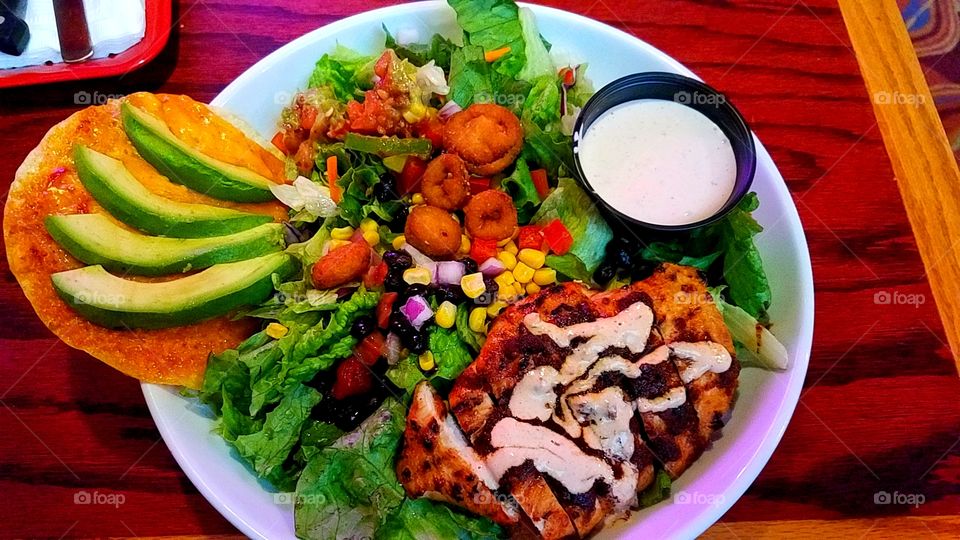Southwestern salad with grilled chicken, avovado, chips and salsa ranch dressing.