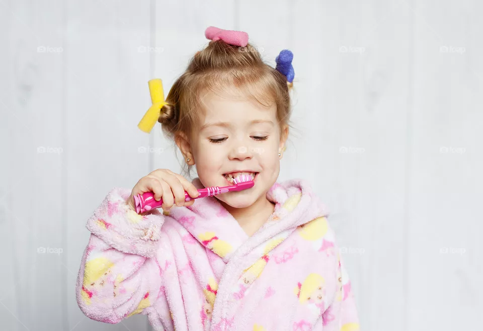 little girl brushing teeth