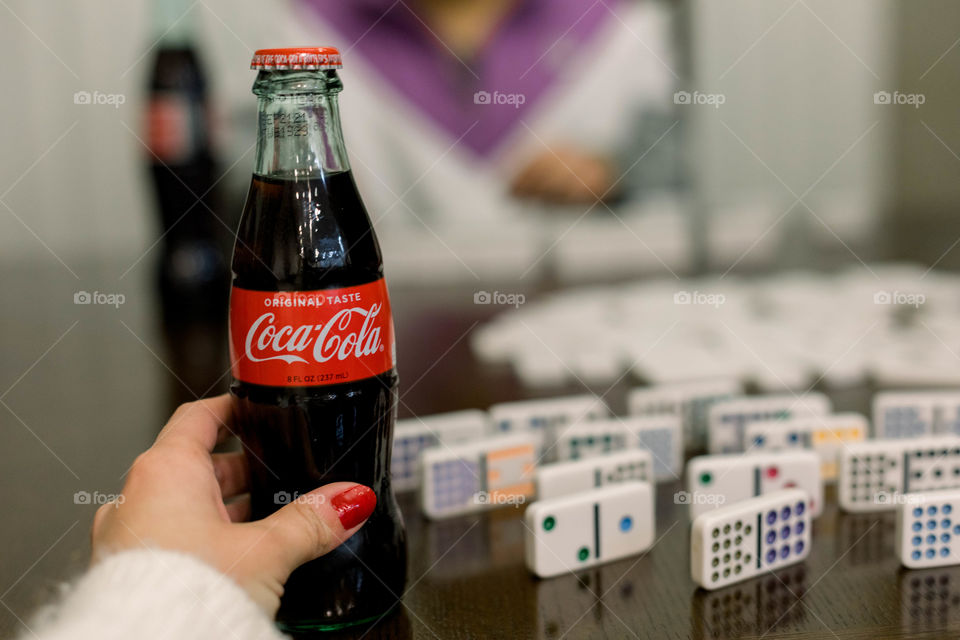 Drinking coke while playing dominoes 