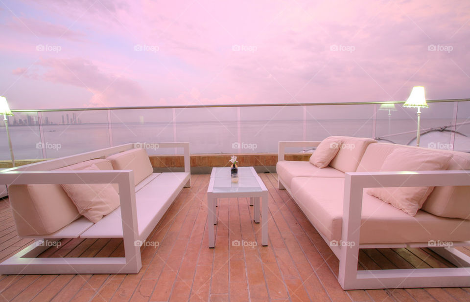 stunning view of outdoor chairs and a couch to enjoy the sunset of the