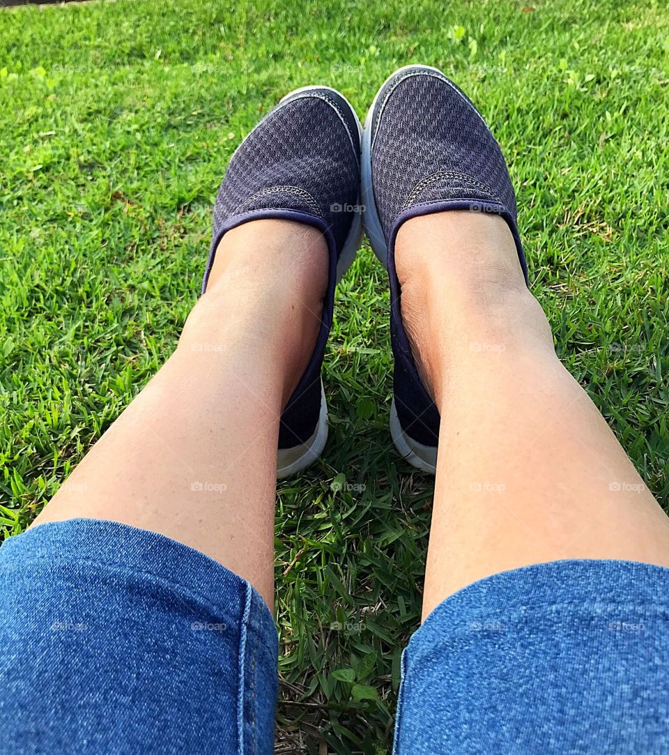 Feet resting on the lawn