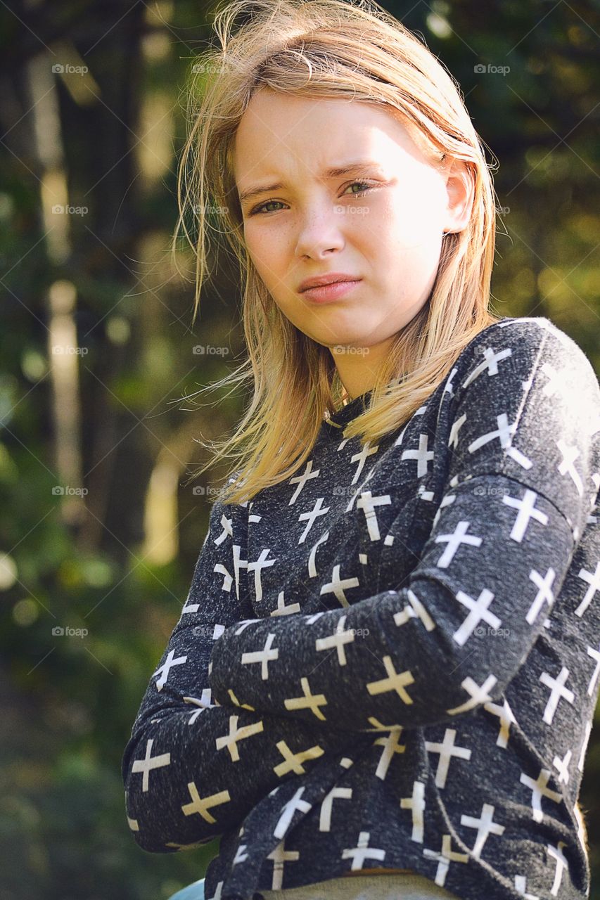 Portrait of teenager blonde girl looking at camera