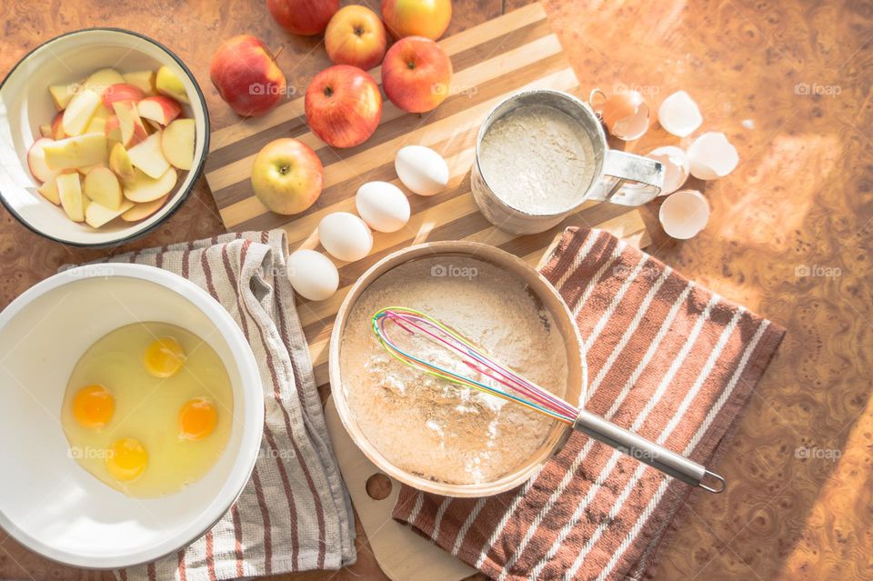 Making homemade puffed apple pie with eggs, sugar and flour.