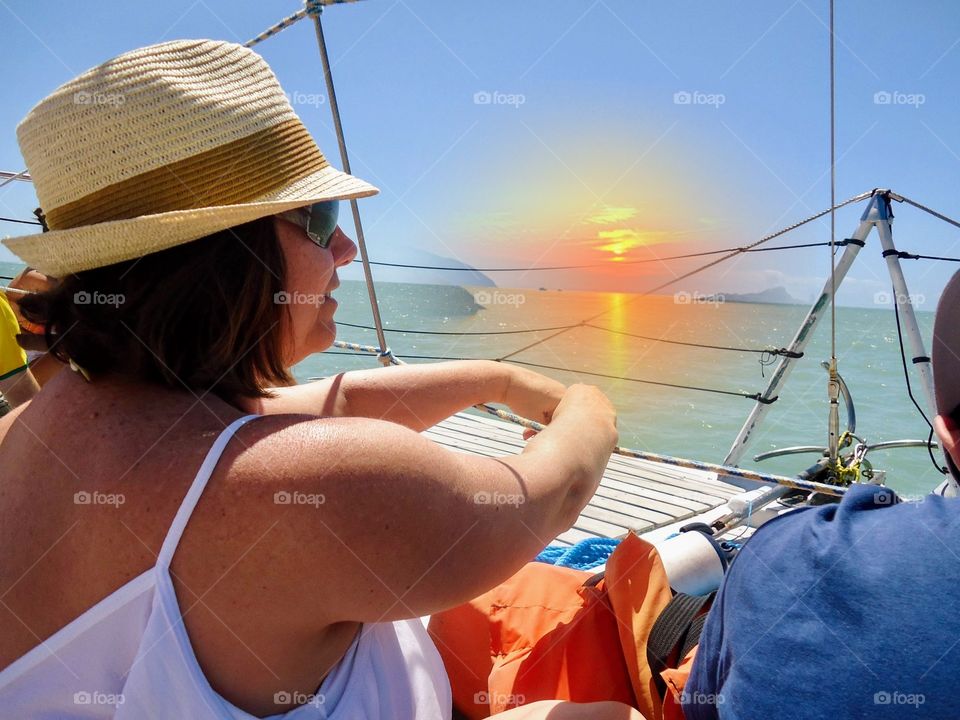 Summer vacation on board a boat, watching the sunset