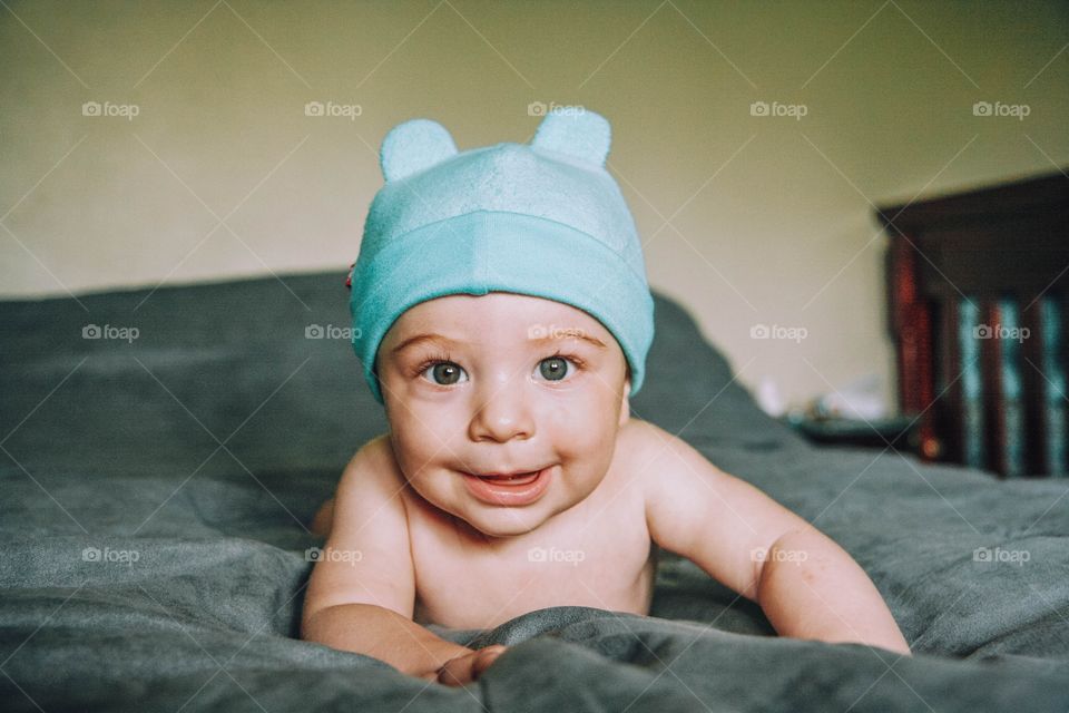 Baby smiling wearing cute hat