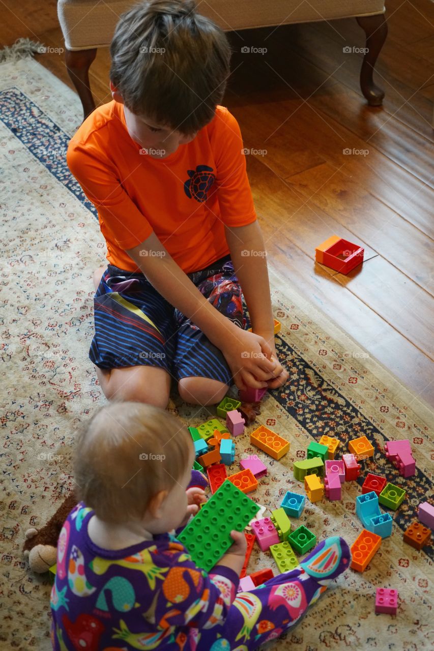 Young Boy Playing With Colorful Toys