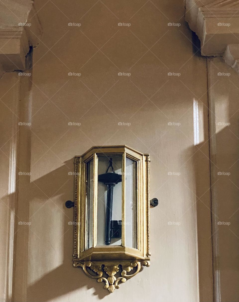 a black key inside a glass holder hung up on a wall