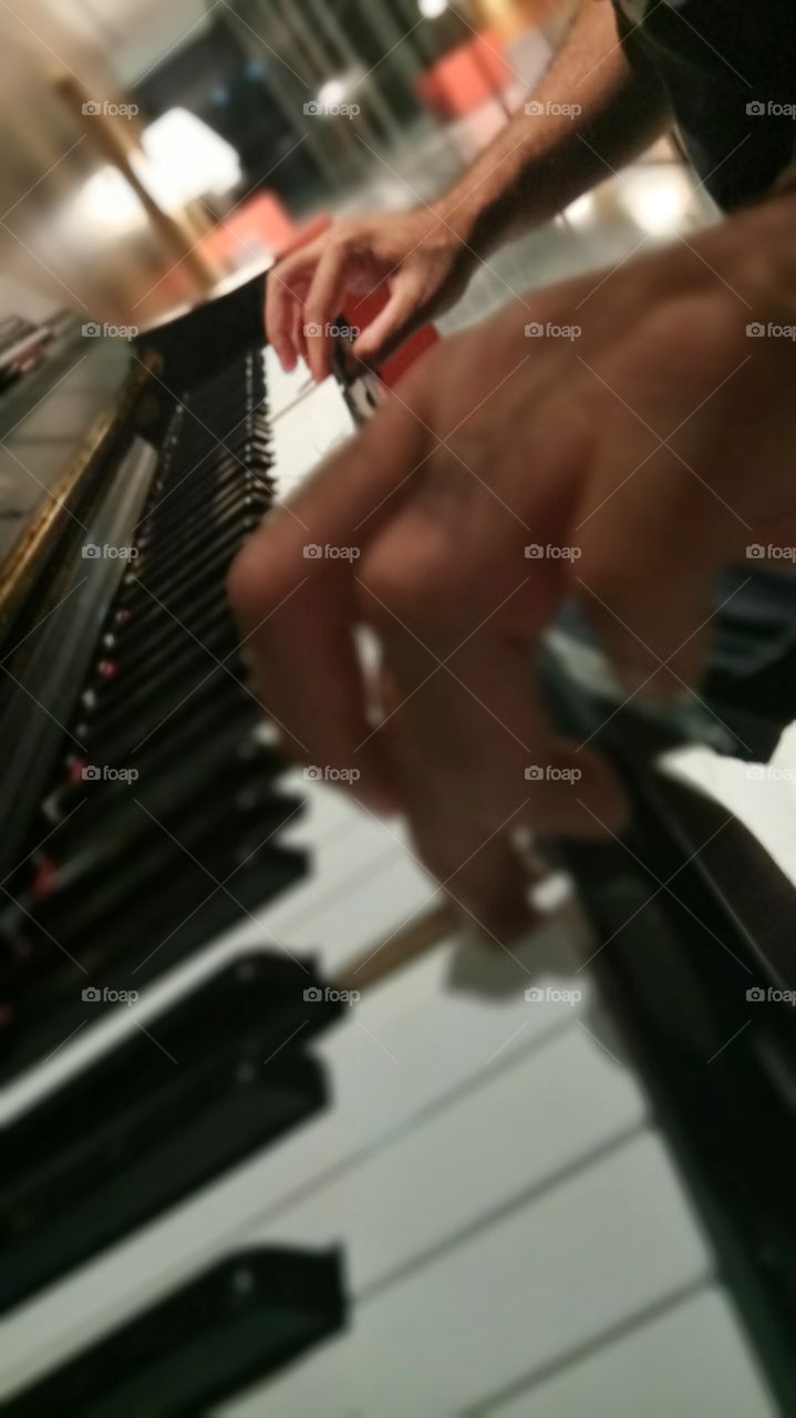 A man is playing piano in Stavros Niarchos foundation cultural center