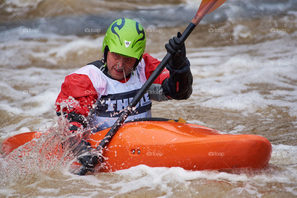 Helsinki, Finland -  April 15, 2018: Unidentified racer at the annual Icebreak 2018 whitewater kayaking competition at the Vanhankaupunginkoski rapids in Helsinki, Finland.