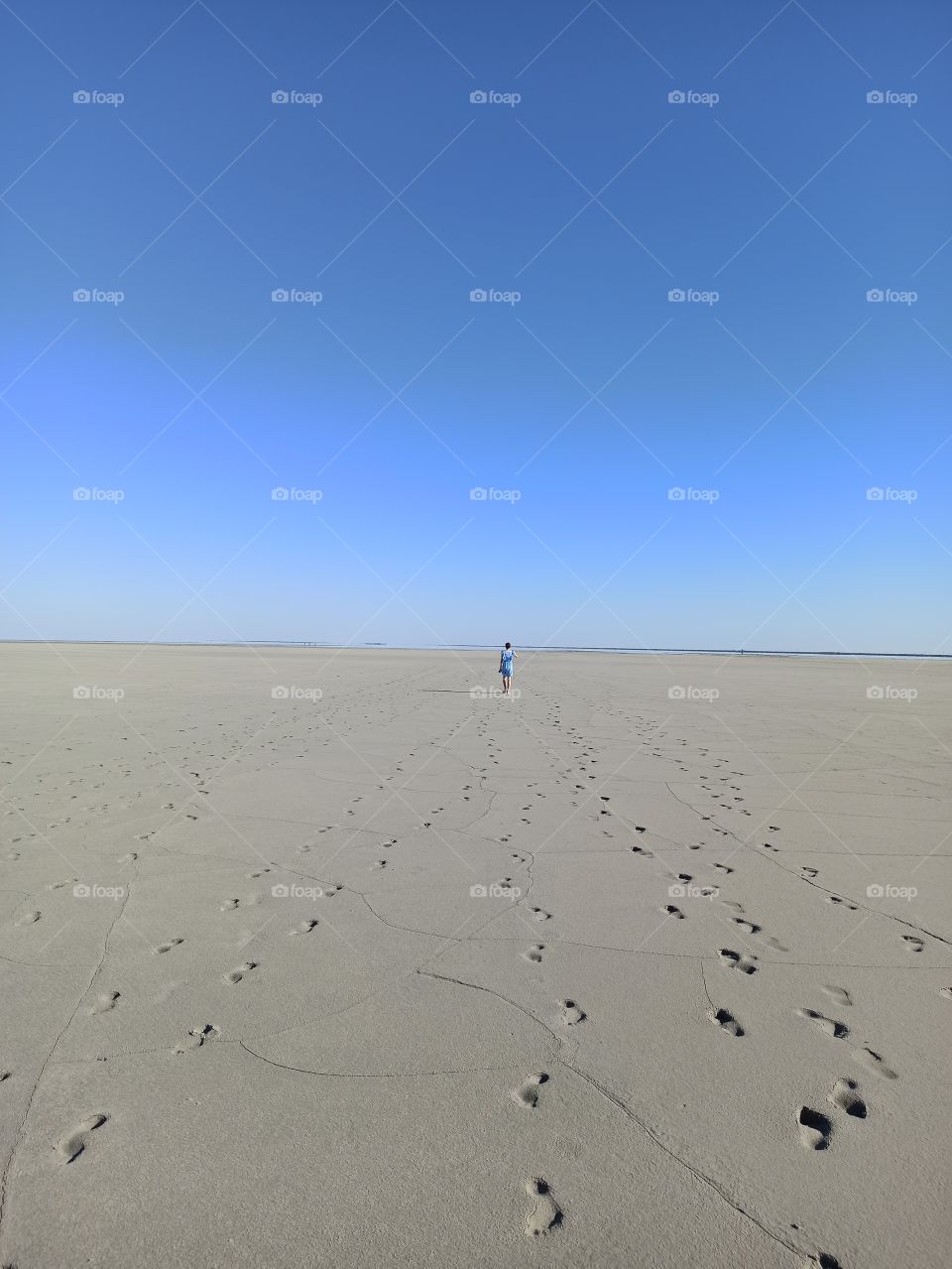 Girl leaving on a deserted beach