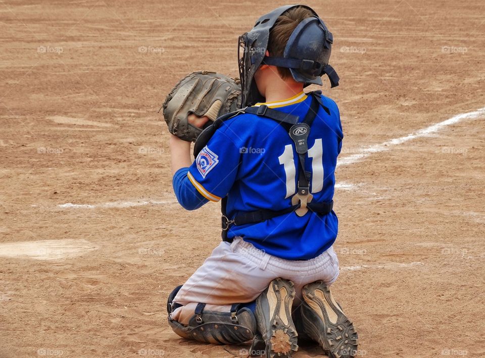 Little League Catcher. Young Boy Playing Position Of 
Catcher On Little League Team