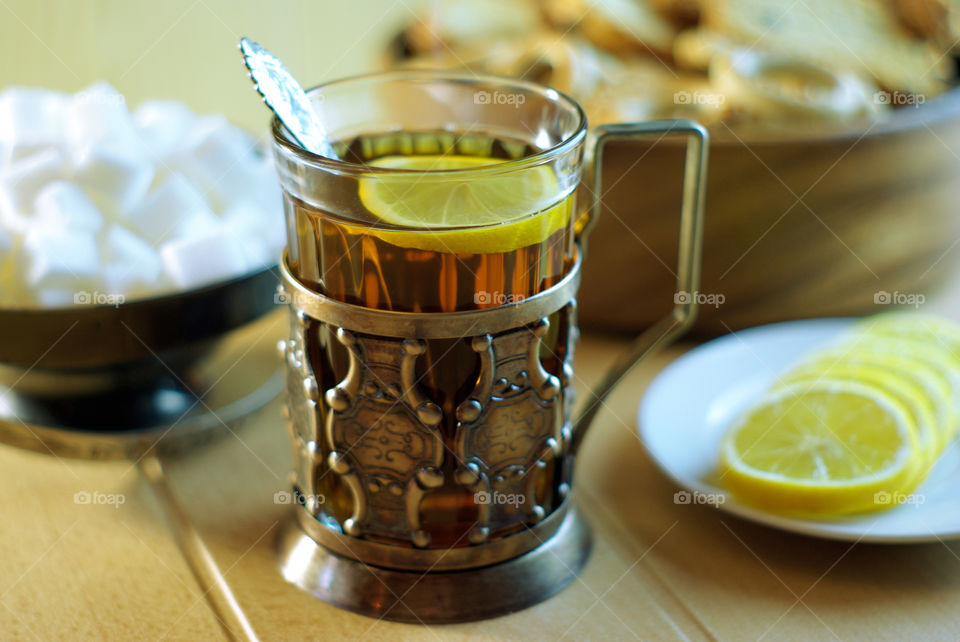 Lemon tea in an old cup holder