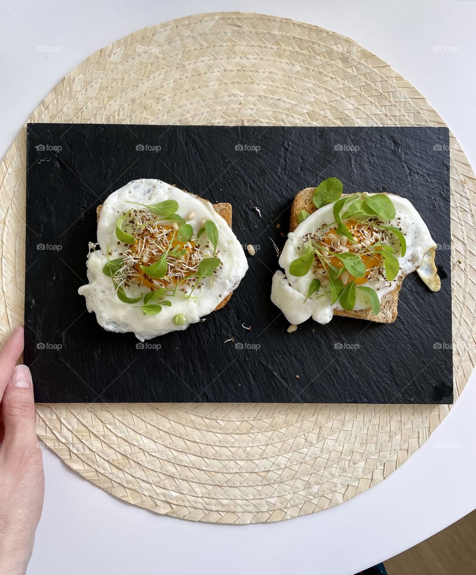 scrambled eggs sandwich on black board