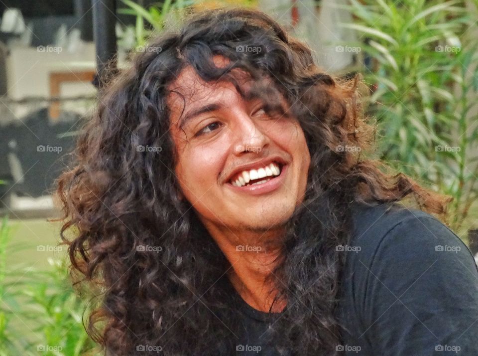 Curly Hair. Handsome Young Man With Bright Smile And Big Curly Hair
