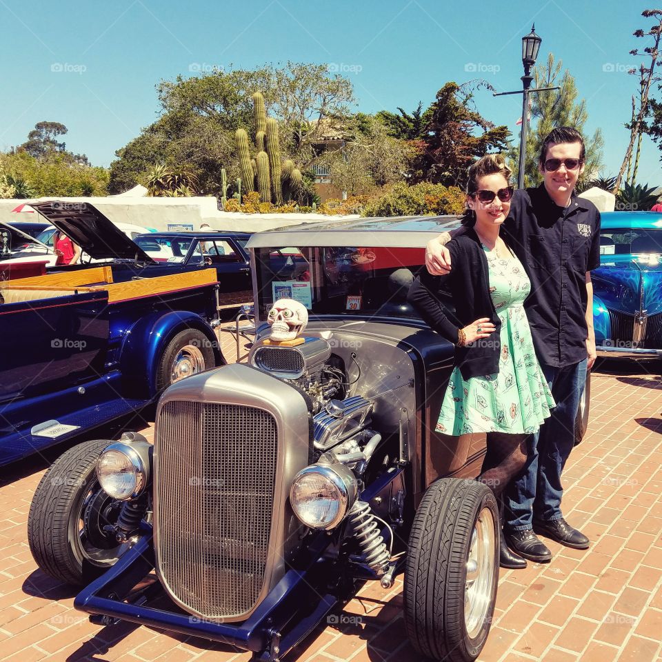 Retro Rocksbilly Couple Posing at Carshow with Hotrod Vintage Car