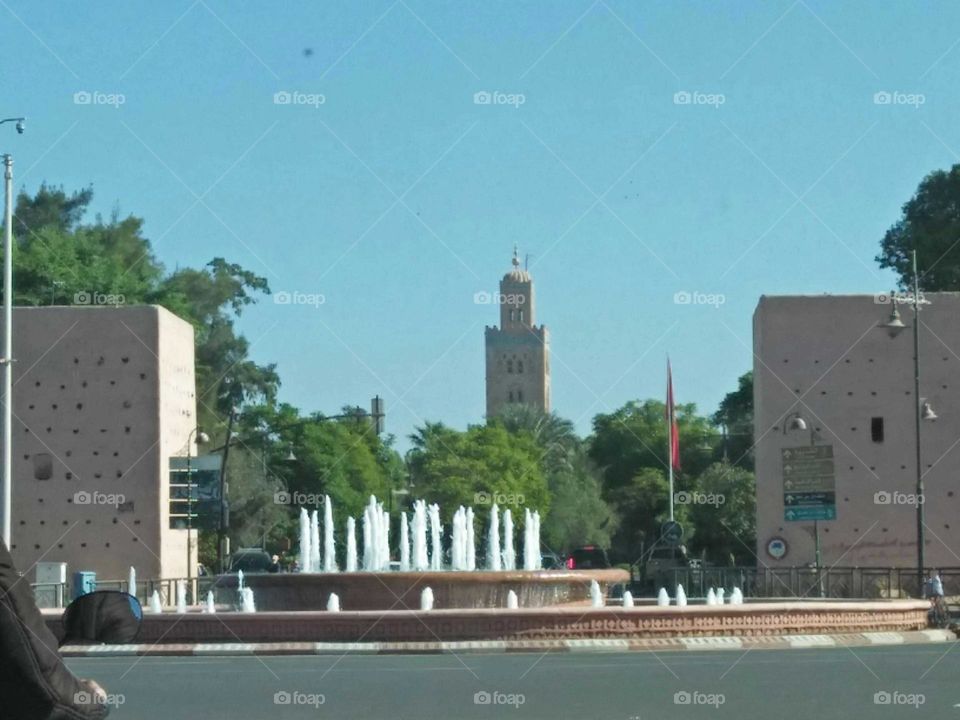 Beautiful fountain and view to Kotoubia minaret mosque at marrakech city.