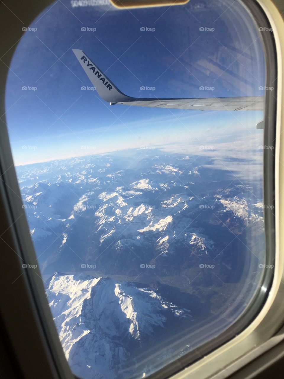 View from the porthole of the airplane on the Alps,Dolomites 