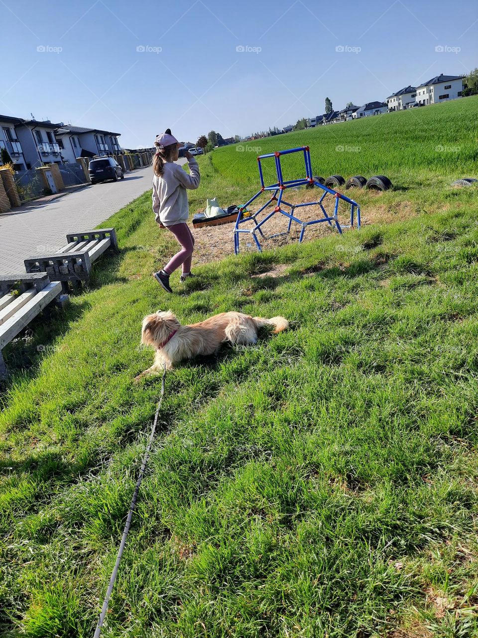 litlle girl with her dog on playground