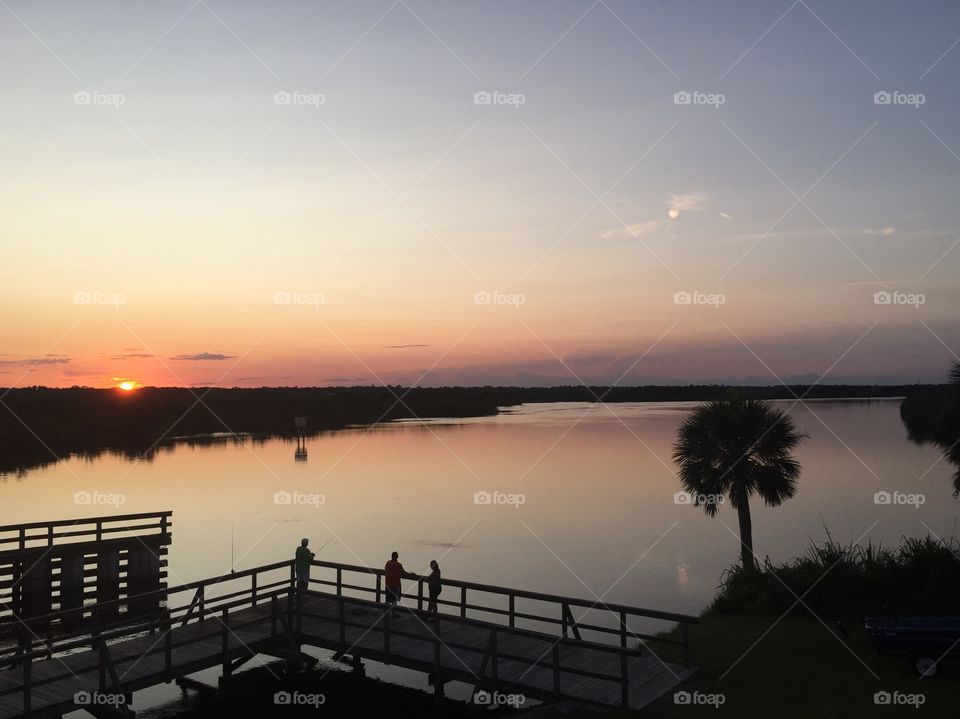 Fishing dock at sunset overlooking Florida inter coastal waterway.