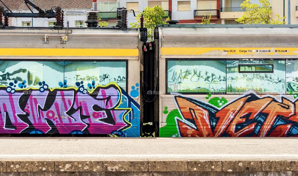 Graffitied train carriages at a platform