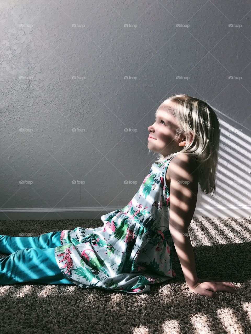 Little girl covered in shadows and light. 