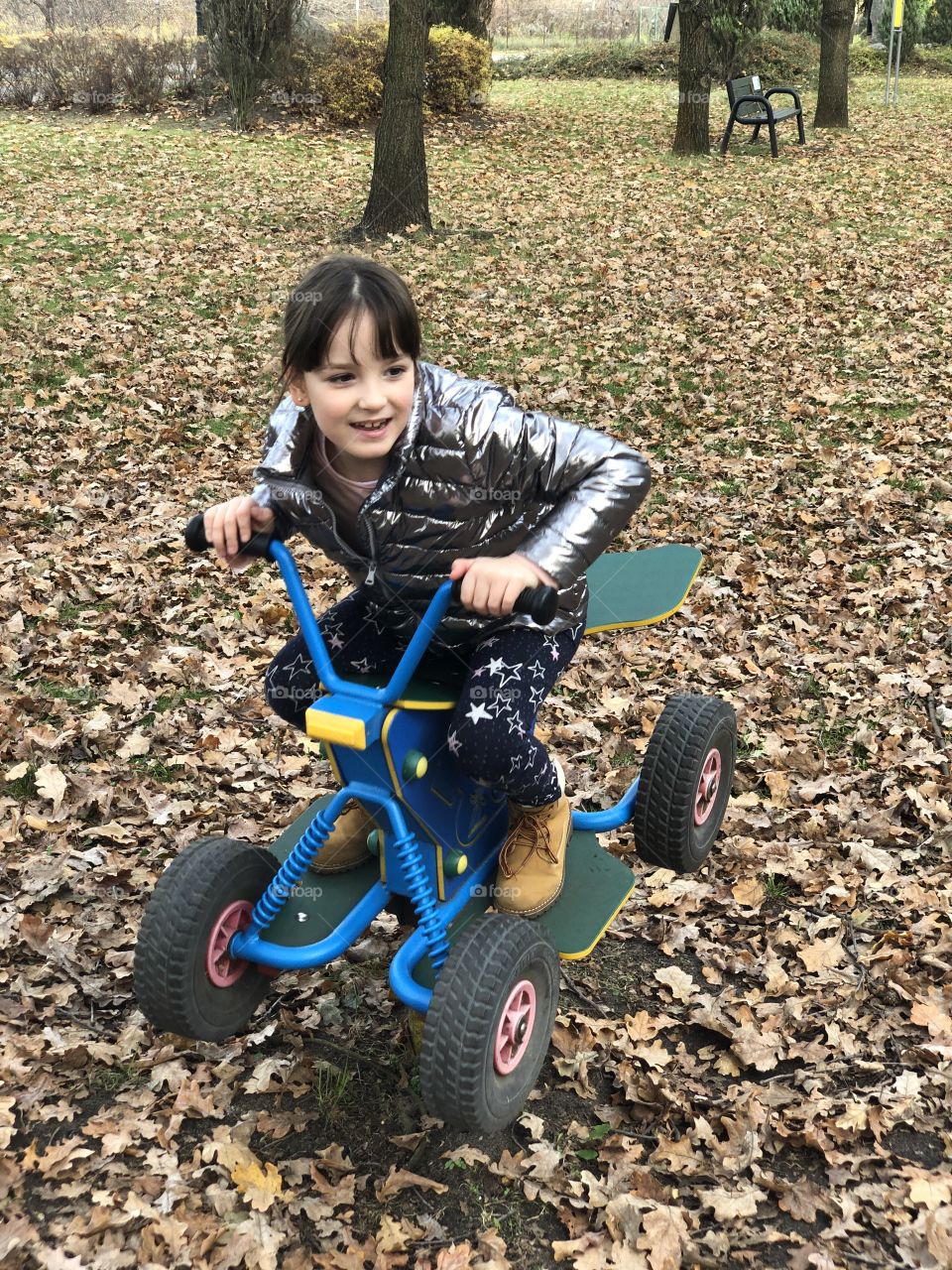 Little girl playing on toy car