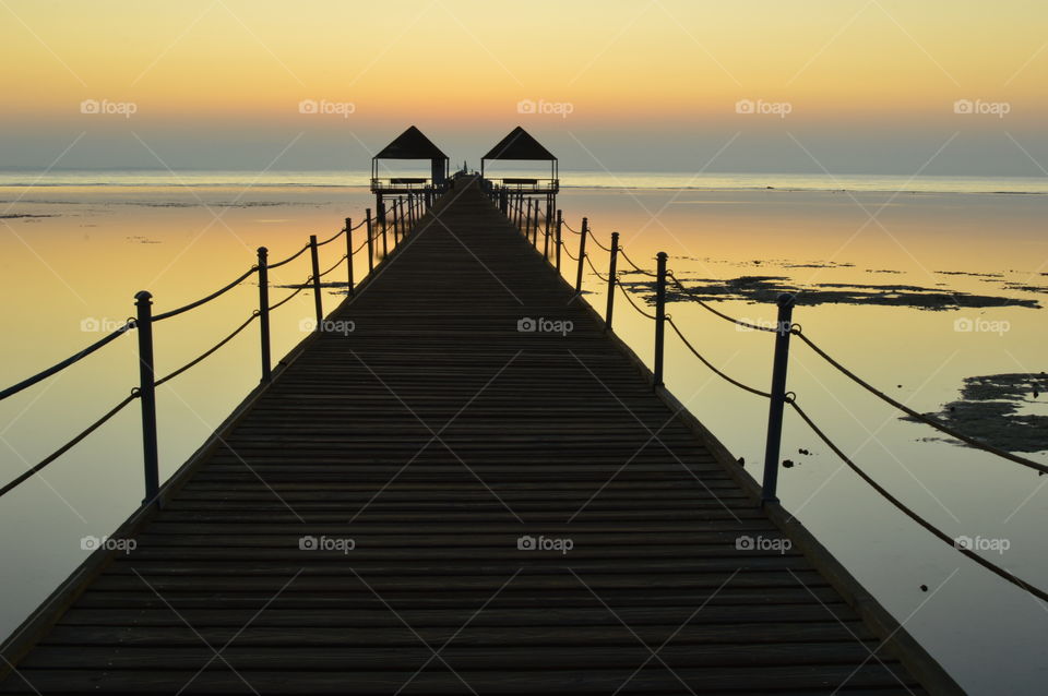 silhouette of a pier at dawn