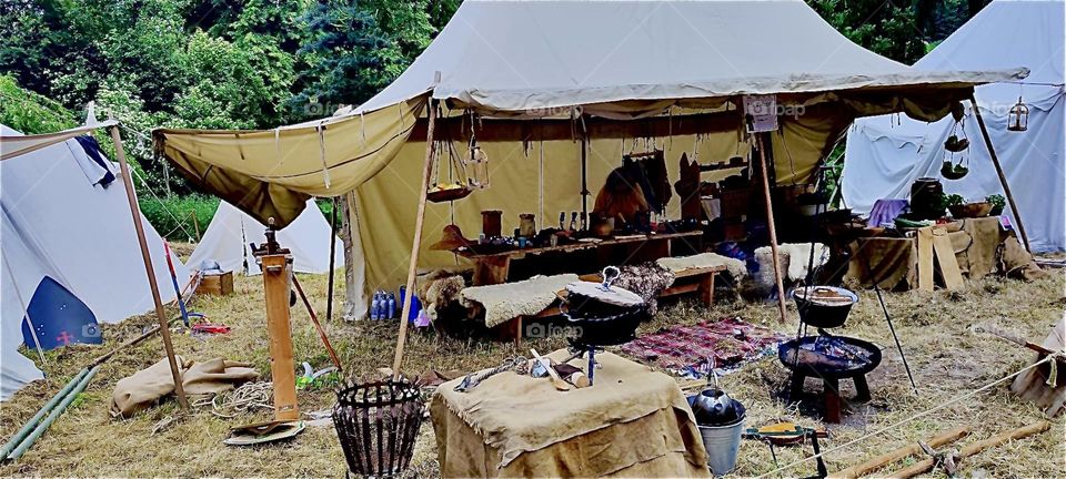 Various stands underneath a large linen tent offer their merchandise to the public as part of the “Renaissance Festival” in “Ortenburg”, Germany from pottery, rugs to clothing and other medieval inspired specialties. 2023. Hypnotic Productions