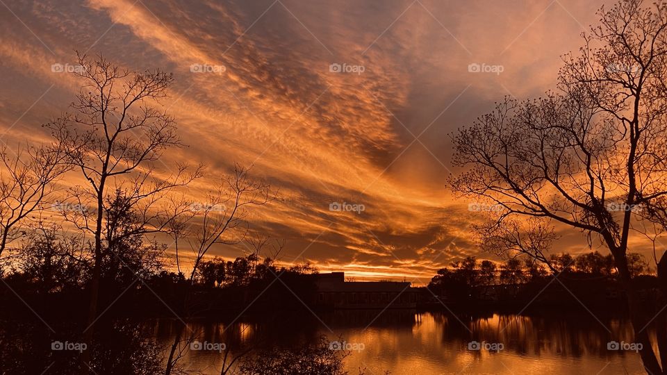 Evening when the sky and clouds perform perfectly. Extraordinary Beautiful Colors that set up for Reflections, silhouettes. 