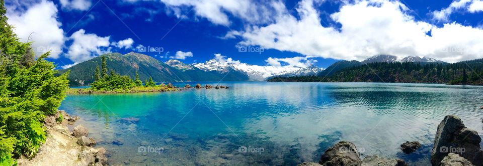 A gorgeous turquoise coloured glacial lake surrounded by tall peaks and a glacier