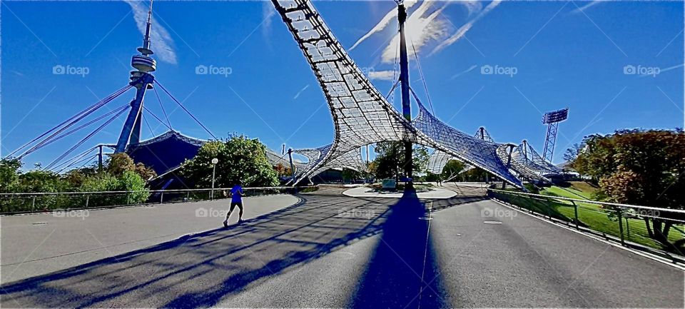 The streamlined design of the „Olympic stadium“ in „Munich“, Germany was built specifically to house the 1972 games, a series of sports events that attracted an audience of fans from around the World. 2022. Hypnotic Productions