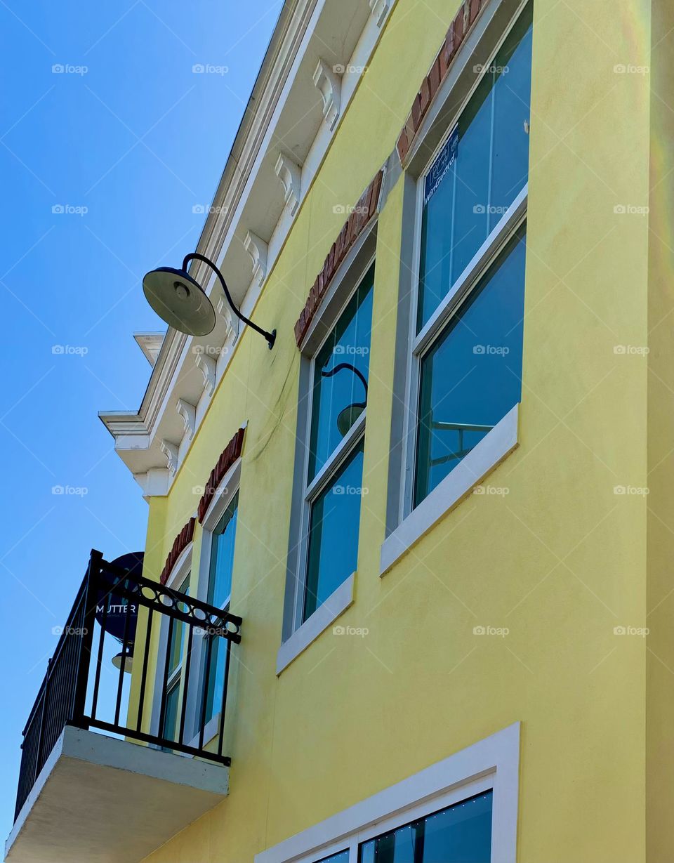 European style architectural top of commercial and historical yellow charming building from balcony.