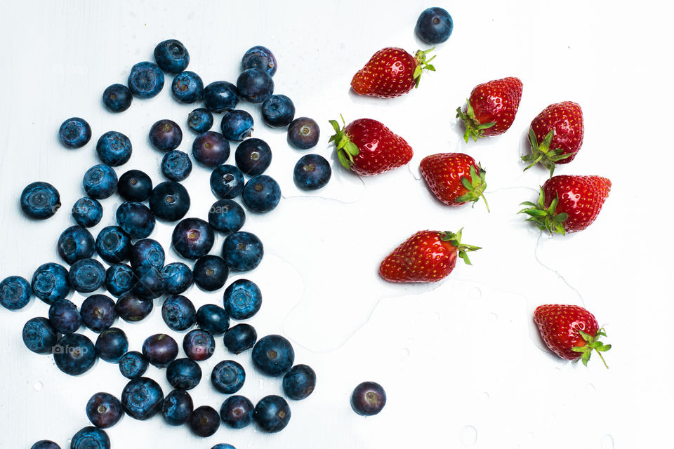 blueberries and strawberries on white background