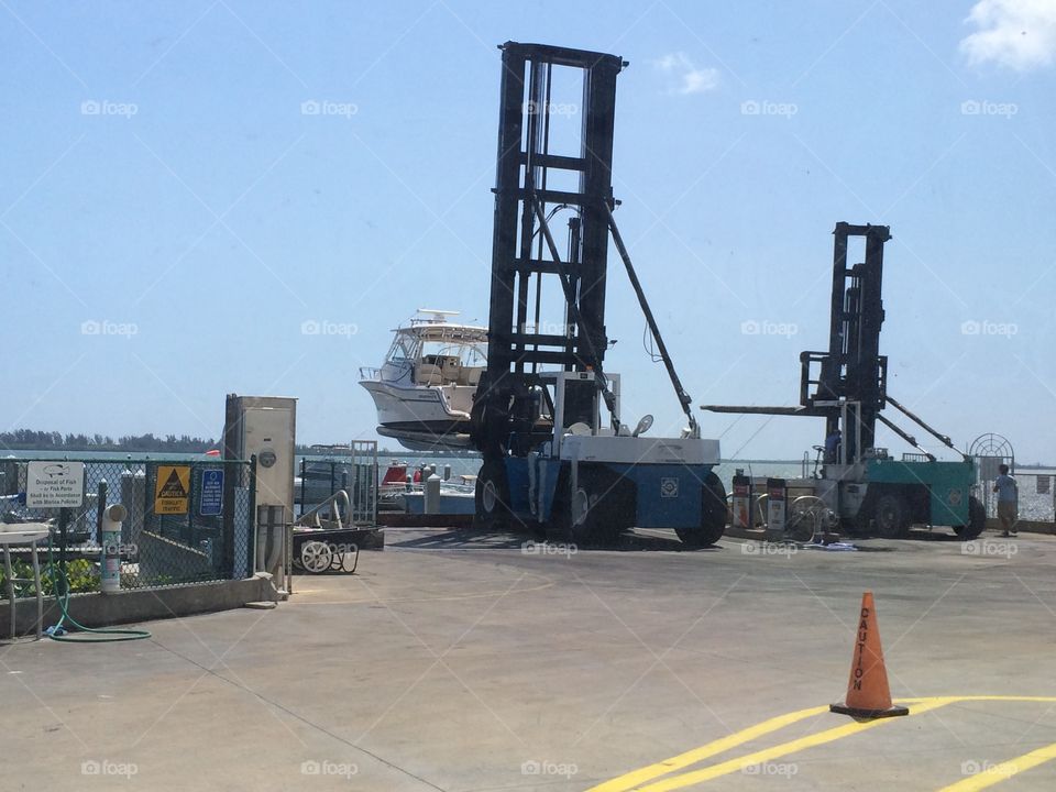 Boat being lifted out of the water to be put in dry storage.