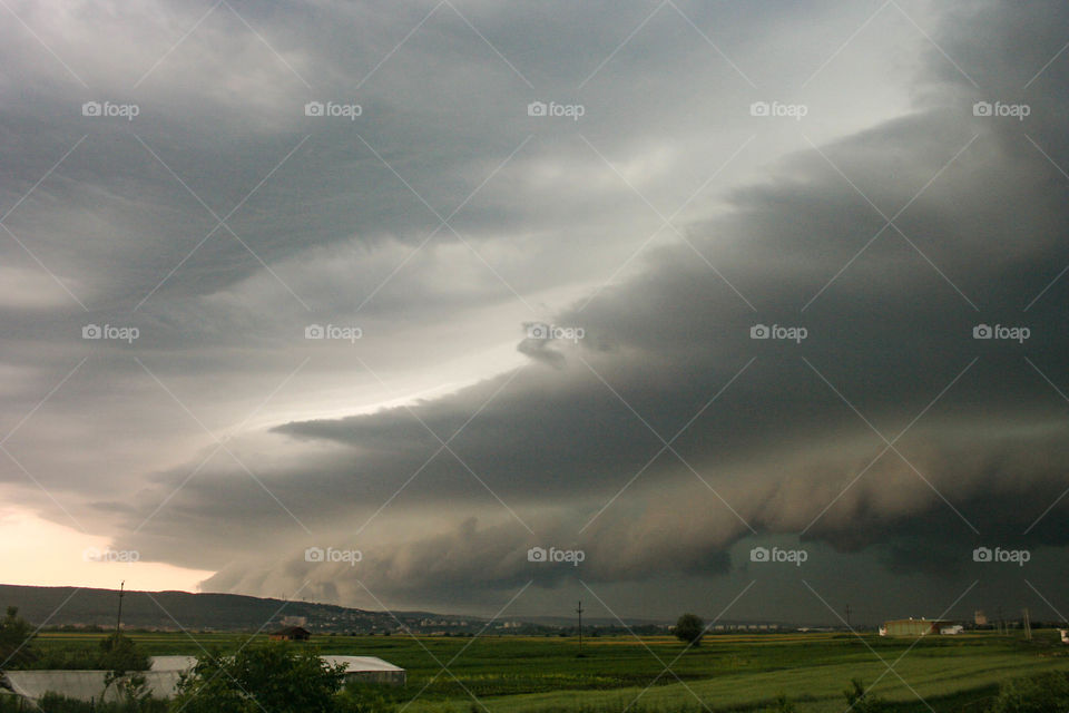 An ominous looking shelf cloud of a severe thunderstorm approaches the city of Targu Mures in Transylvania, Romania.