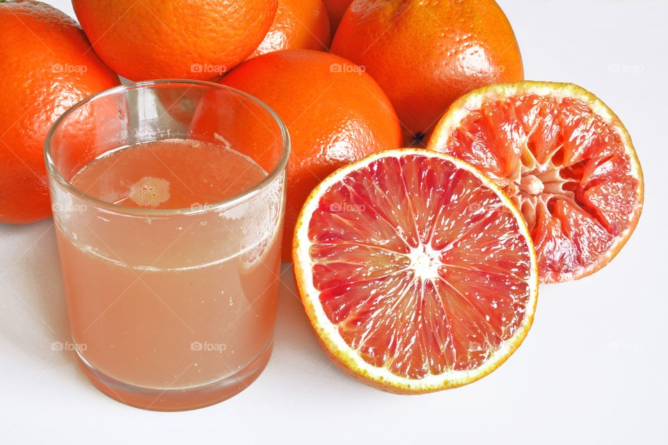 Glass of grapefruit juice with slice fruits