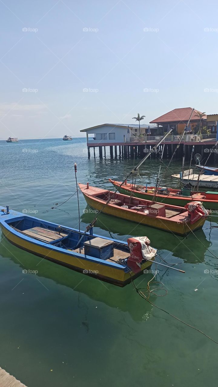 blue and red boats and clear water