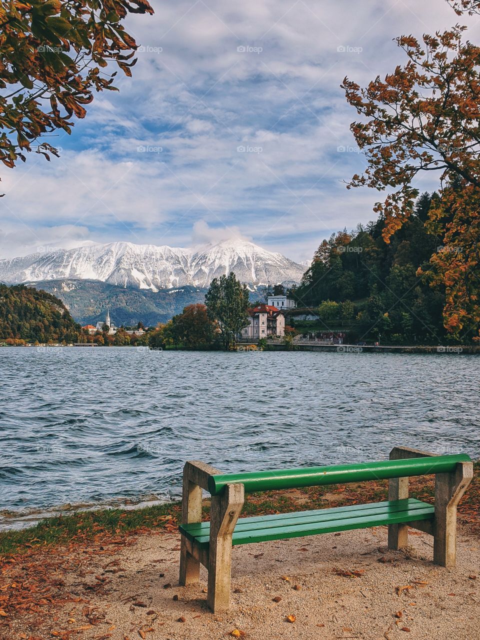 Scenic view of the snowcovered mountains against the blue lake Bled.