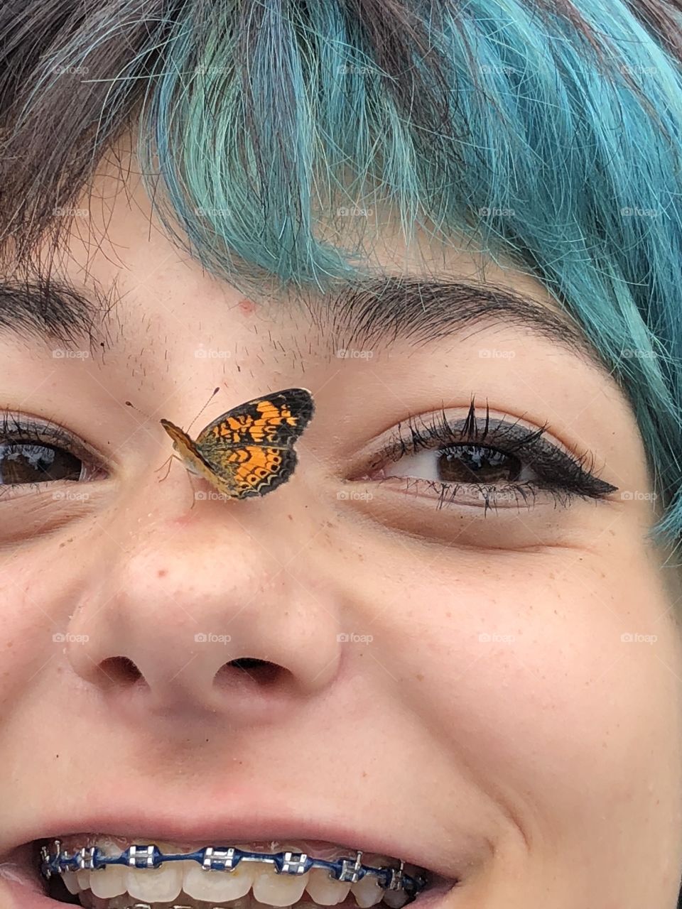 Tiny butterfly landed on her nose happy and amazing 