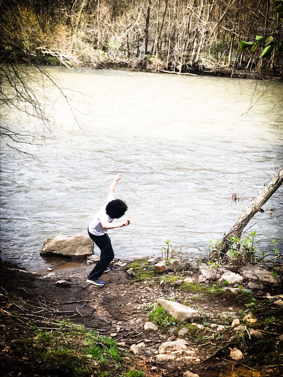 Rock skipping at the river.