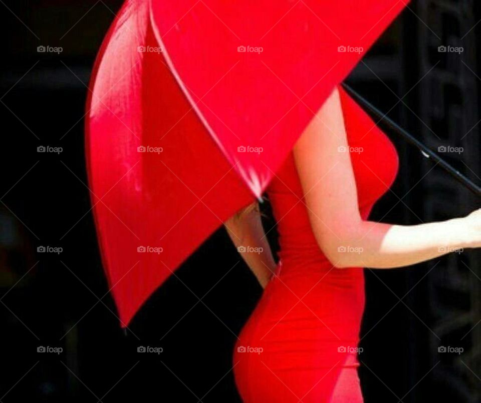 Women in red dress holding red umbrella