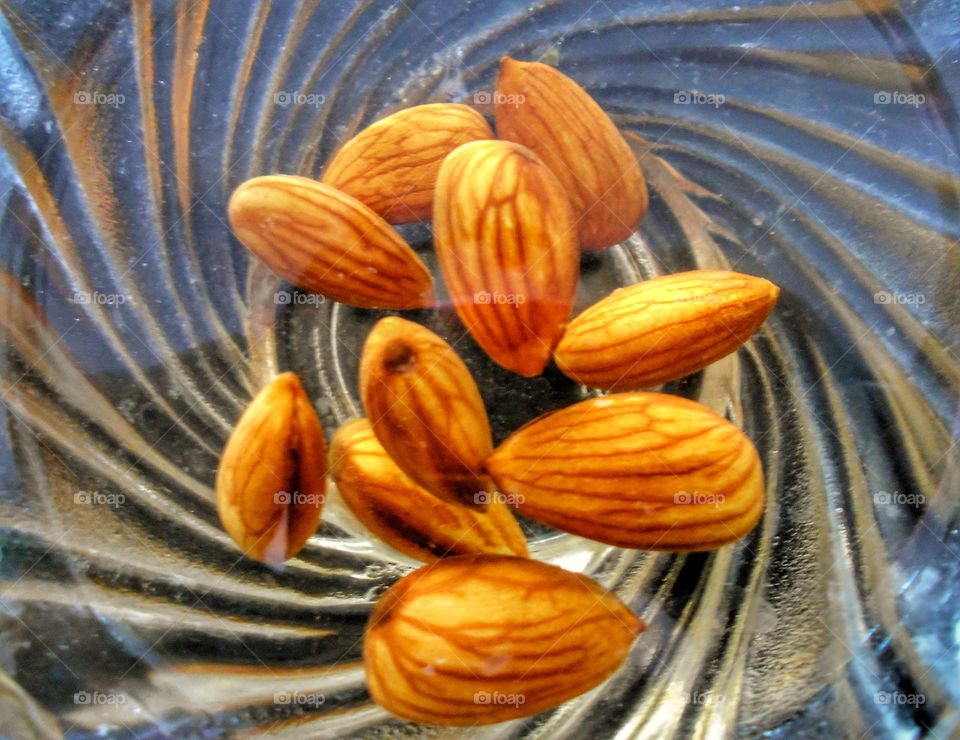 soaked almonds in glass bowl
