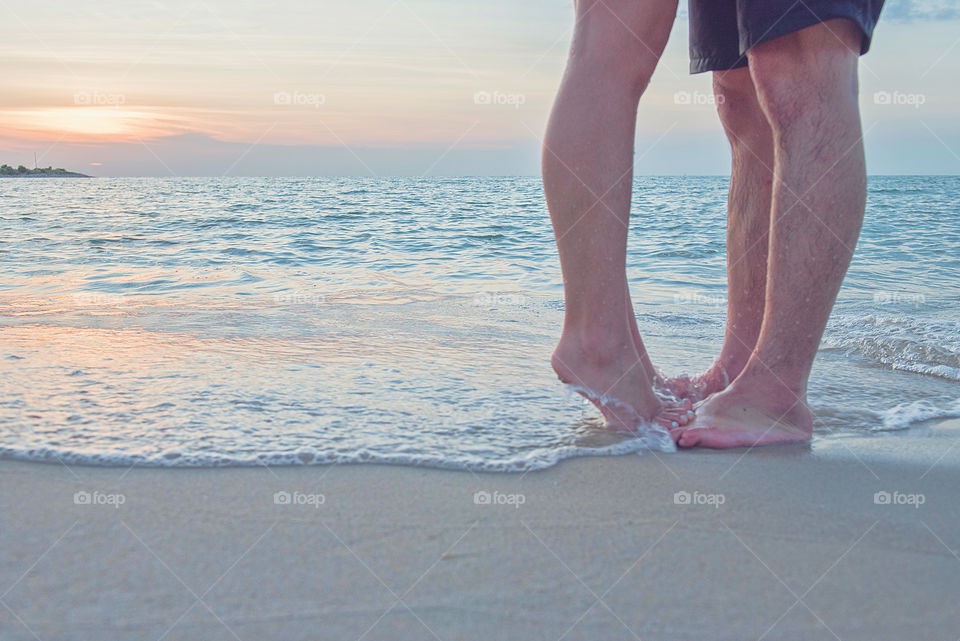 Couple standing against wave