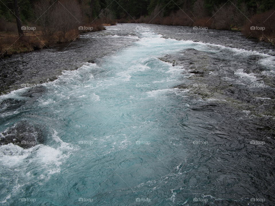 The magnificent Metolius River at Wizard Falls with a morning fog on a cold winter day. 