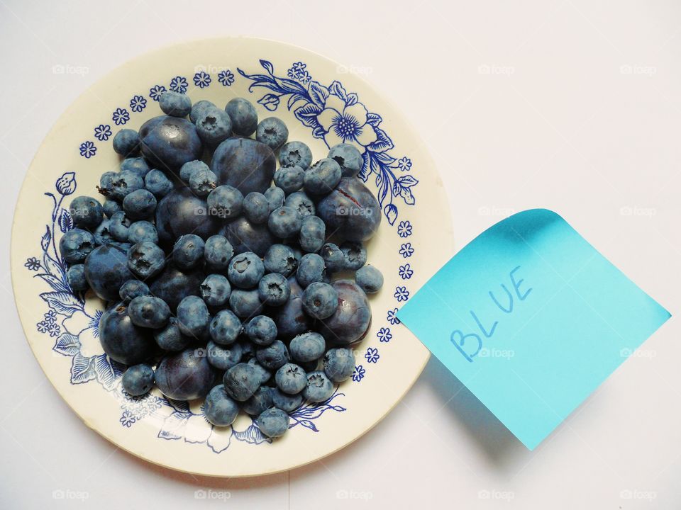 blueberries and plums on a plate