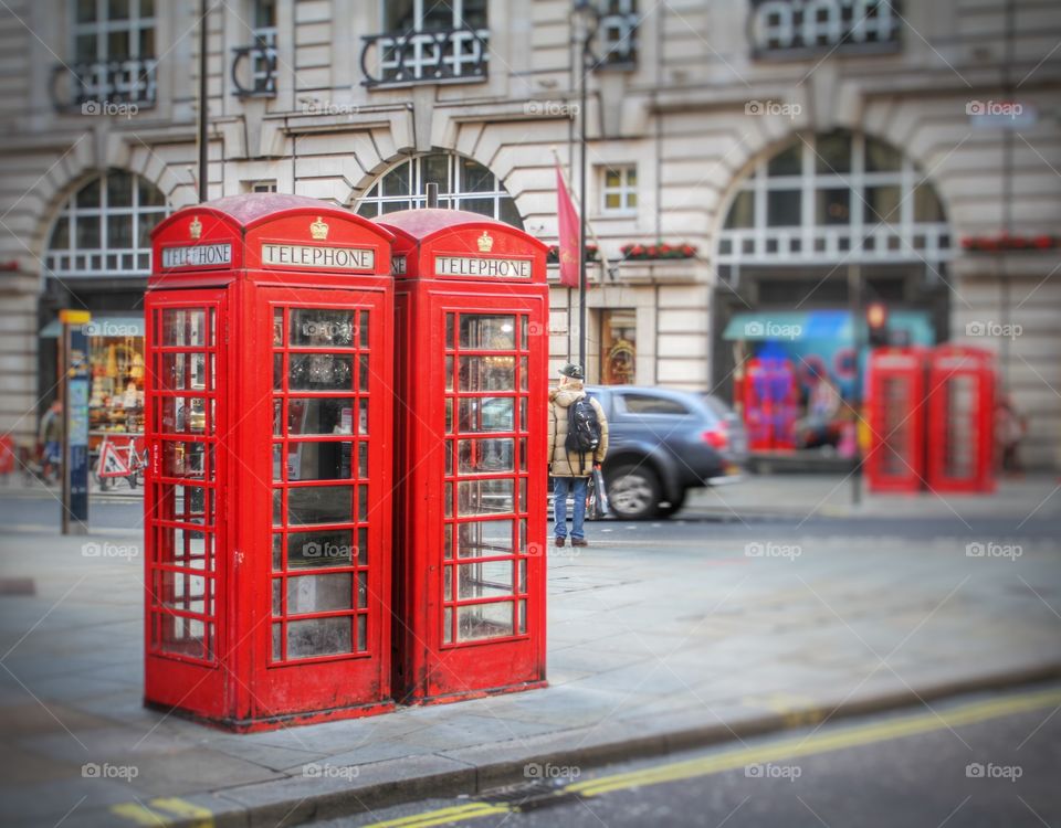 Red phone boxes on the streets of London .