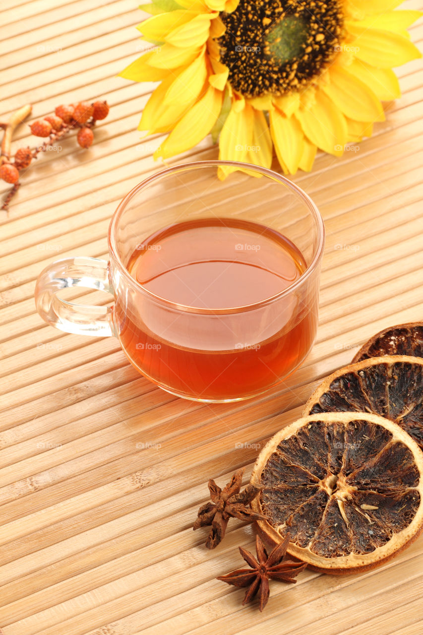 Tea cup on a wooden background with sunflower