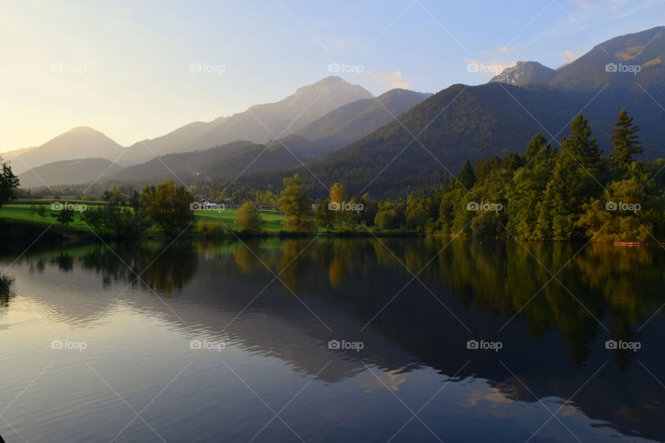 Reflection of trees and mountain on lake
