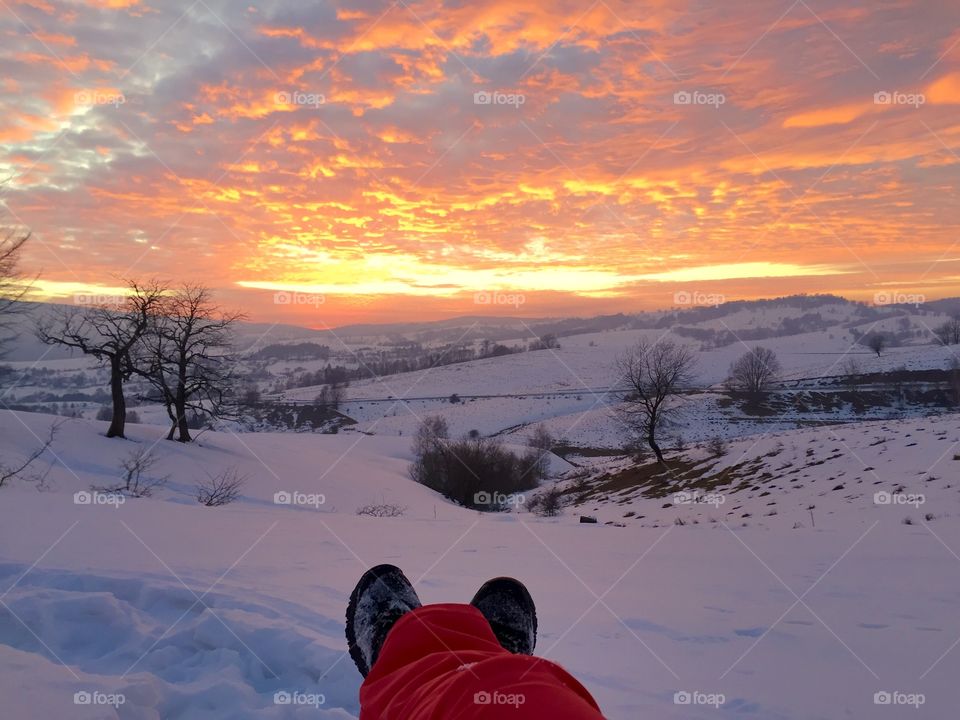 Selfie of feet while wathcing the sunset in winter