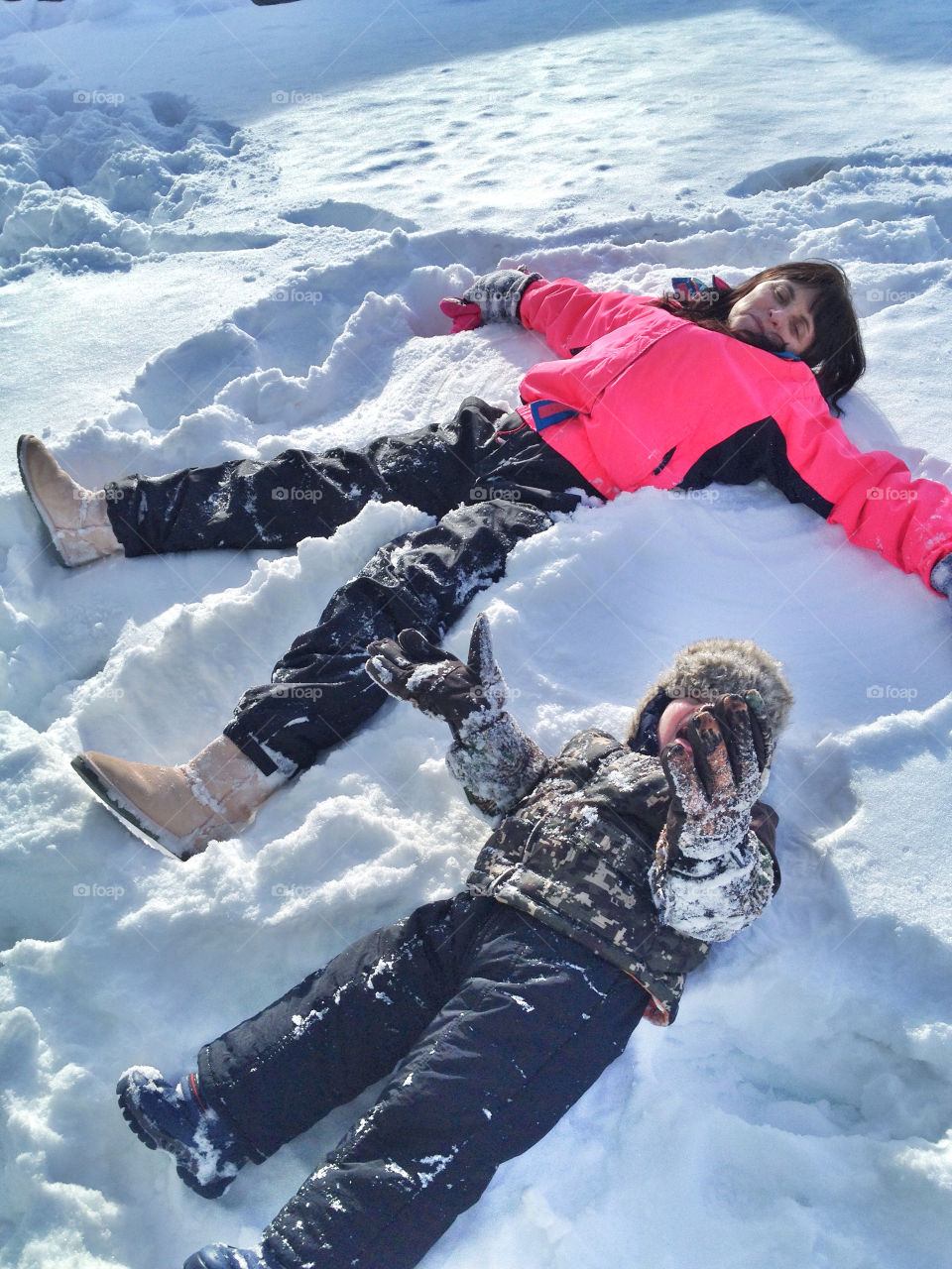 Teaching mason how to make snow angels